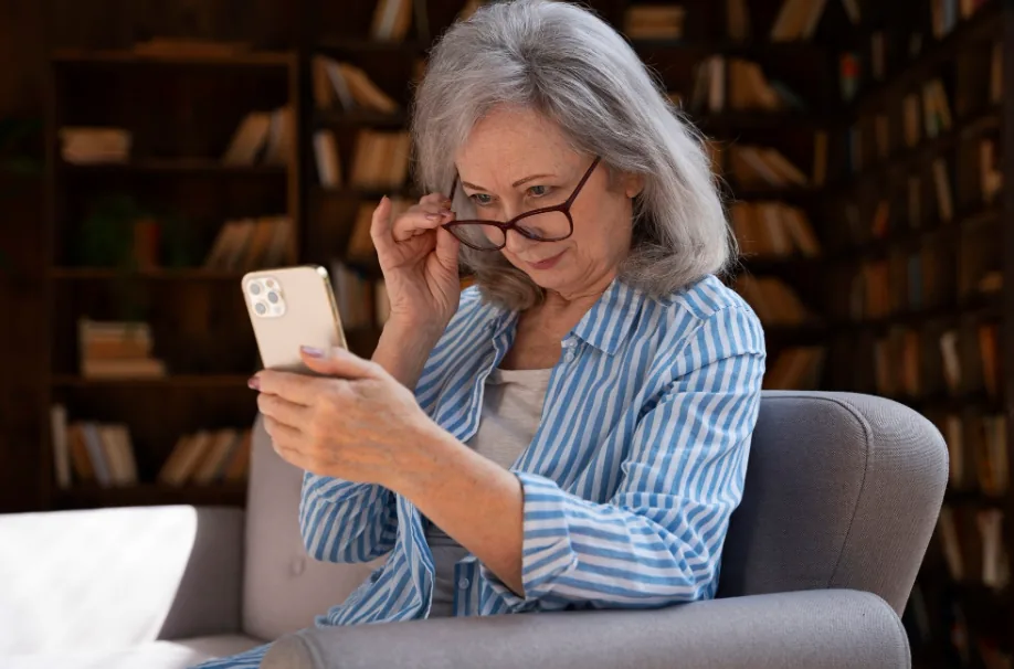 Senior woman using her smartphone to schedule non-emergency medical transportation
