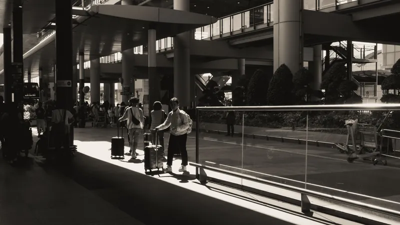 Travelers with luggage at an airport terminal, representing long-distance and airport medical transport