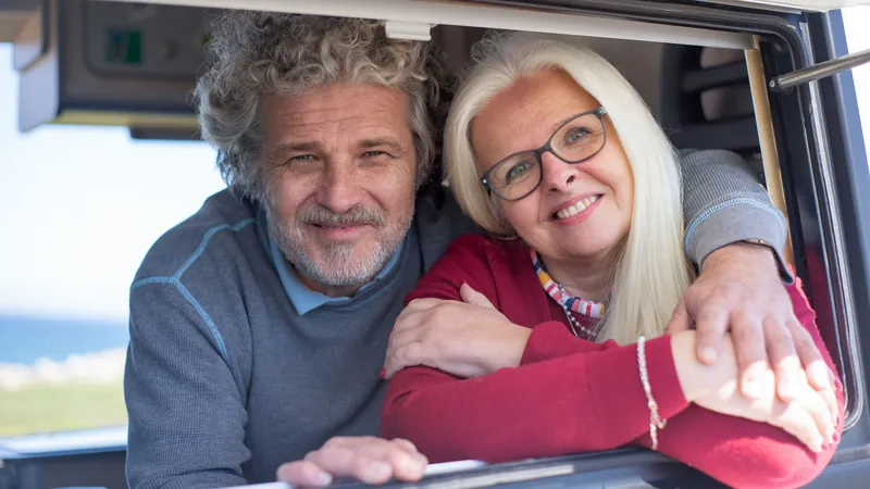 Smiling senior couple enjoying a comfortable private-pay medical transport ride